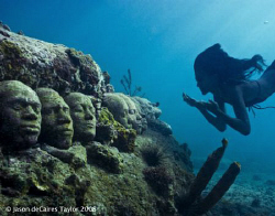 Marie free dives down to underwater faces. Jason deCaires... by Jason Decaires Taylor 